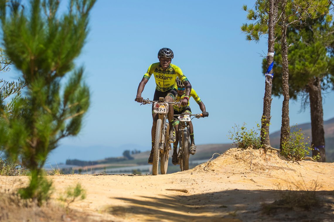 Masixole Zondani and Kabelo Maduna during stage 1 of the 2022 Absa Cape Epic Mountain Bike stage race from Lourensford Wine Estate to Lourensford Wine Estate, South Africa on the 21st March 2022. © Dom Barnardt / Cape Epic