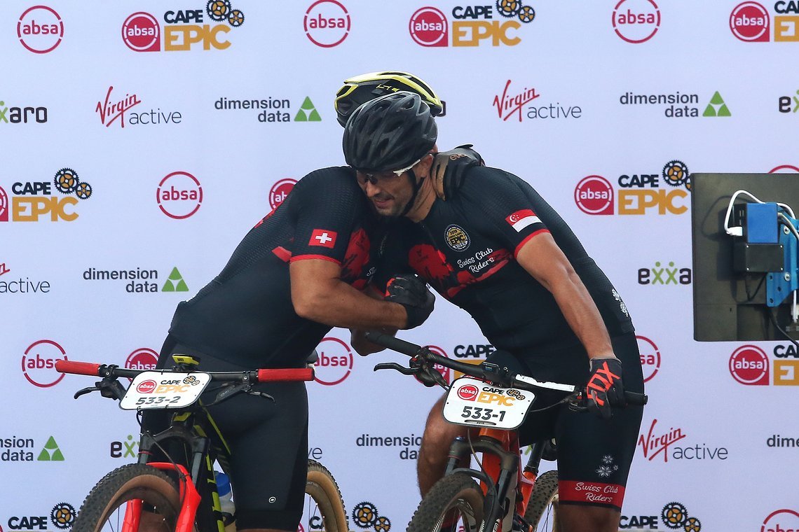 Steve Knabl and Thibaud Grizard of the BarBarians embrace before setting off during the Prologue of the 2019 Absa Cape Epic Mountain Bike stage race held at the University of Cape Town in Cape Town, South Africa on the 17th March 2019.

Photo by Sh
