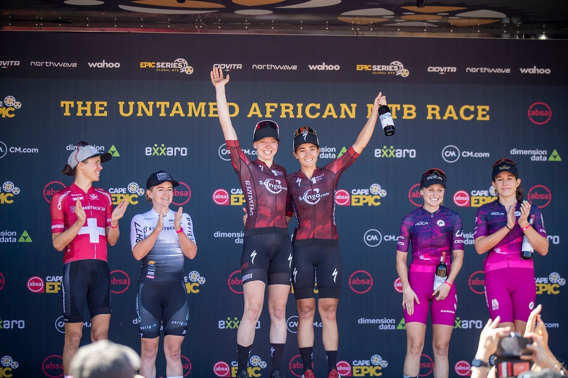 Women’s podium (L to R) Ariane Luthi & Amy Wakefield of Symbtech ZA (2nd), Haley Batten & Sofia Gomez Villafane of NinetyOne-Songo-Specialized (1st) and Mariske Strauss and Candice Lill of Faces Rola (3rd) during stage 1 of the 2022 Absa Cape Epic Mo