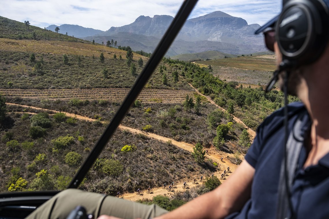 Riders make their way back to Wellington through single track while helicopter pilot Andrew looks on during Stage 5 of the 2024 Absa Cape Epic Mountain Bike stage race from CPUT, Wellington to CPUT, Wellington, South Africa on 22 March 2024. Photo by