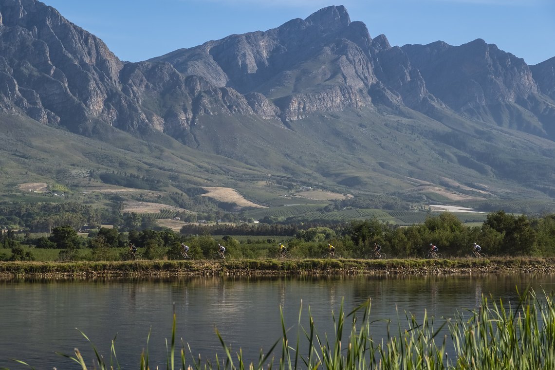 Lead riders on a dam wall during Stage 1 of the 2024 Absa Cape Epic Mountain Bike stage race from Saronsberg Wine Estate to Saronsberg Wine Estate, Tulbagh, South Africa on the 18th March 2024. Photo by Dominic Barnardt / Cape Epic
PLEASE ENSURE THE 