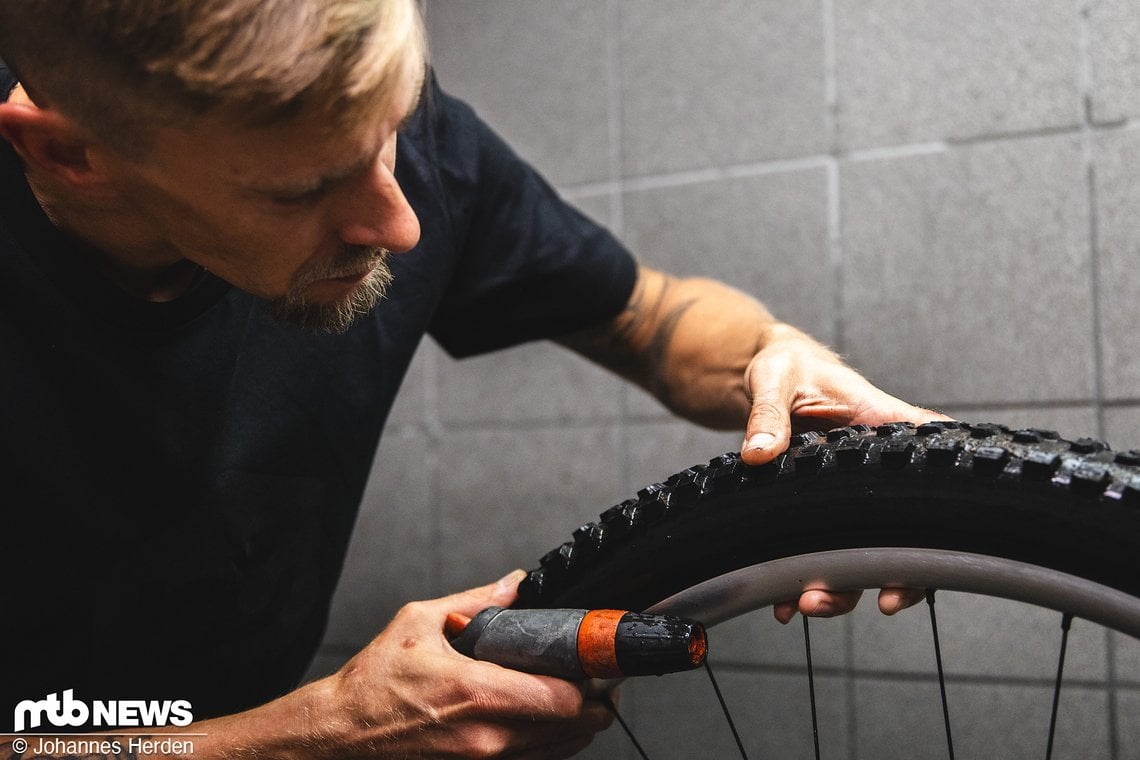 Tommy überprüft das Bike direkt nach dem Reinigen auf Beschädigungen. Risse im Reifen? Fühlen!