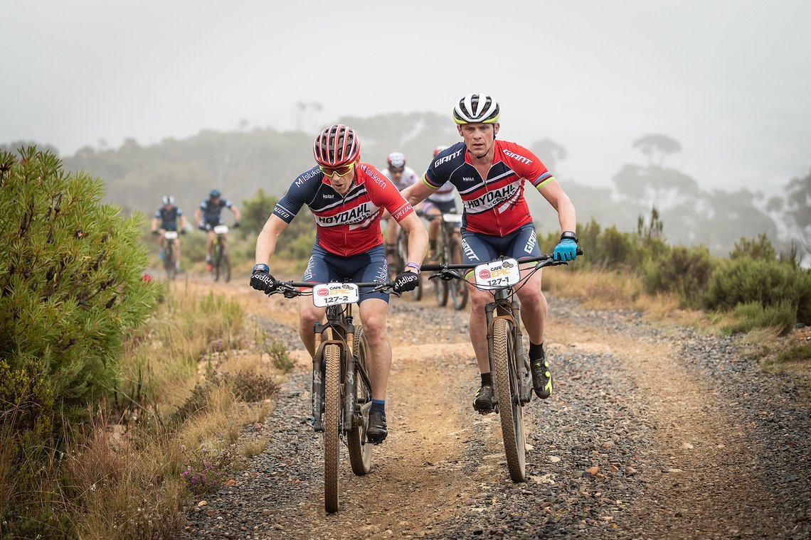 Rider helping his team mate up a climb during the Prologue of the 2019 Absa Cape Epic Mountain Bike stage race held at the University of Cape Town in Cape Town, South Africa on the 17th March 2019.

Photo by Xavier Briel/Cape Epic

PLEASE ENSURE 