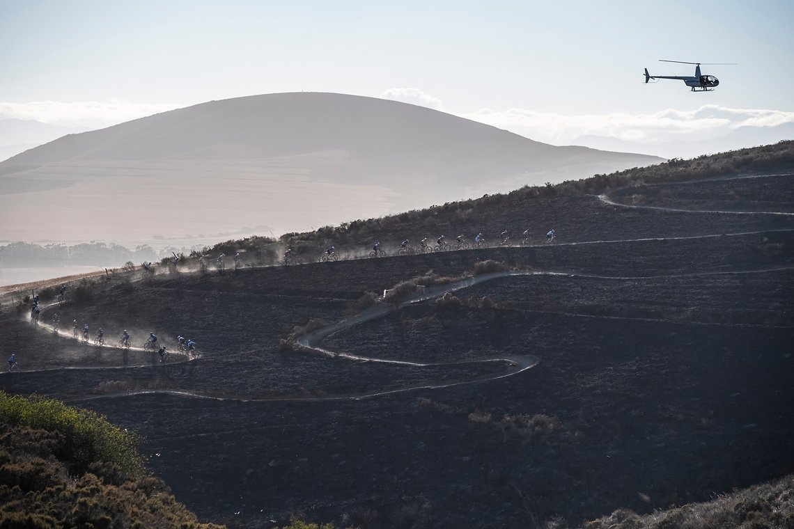 Elite riders head up a windy dusty climb during Stage 1 of the 2025 Absa Cape Epic Mountain Bike stage race held at Meerendal Wine Estate, Cape Town, South Africa on the 17th March 2025. Photo by Dom Barnardt/Cape Epic
PLEASE ENSURE THE APPROPRIATE C