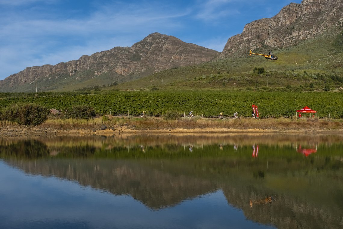Lead riders head past a dam during Stage 1 of the 2024 Absa Cape Epic Mountain Bike stage race from Saronsberg Wine Estate to Saronsberg Wine Estate, Tulbagh, South Africa on the 18th March 2024. Photo by Dominic Barnardt / Cape Epic
PLEASE ENSURE TH