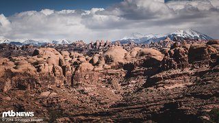 Rote Felsen, schneebedeckte Berge am Horizont Rote Felsen, schneebedeckte Berge am Horizont