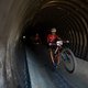 Sergio Mantecon Gutierrez wheelies out of a tunnel under the Helshoogte Pass followed by his Cross Spur team mate Ondřej Cink during stage 6 of the 2019 Absa Cape Epic Mountain Bike stage race from the University of Stellenbosch Sports Fields in Stel