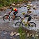 Pro riders cross the small river during stage 4 of the 2022 Absa Cape Epic Mountain Bike stage race from Elandskloof in Greyton to Elandskloof in Greyton, South Africa on the 24th March 2022. © Dom Barnardt / Cape Epic