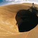 107432-FBA-Mountain-Biker-Cycles-Around-a-Spectacular-Crater-in-the-Desert-Poster