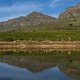 Lead riders head past a dam during Stage 1 of the 2024 Absa Cape Epic Mountain Bike stage race from Saronsberg Wine Estate to Saronsberg Wine Estate, Tulbagh, South Africa on the 18th March 2024. Photo by Dominic Barnardt / Cape Epic
PLEASE ENSURE TH