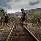 Riders cross the train tracks near Bot River during stage 2 of the 2019 Absa Cape Epic Mountain Bike stage race from Hermanus High School in Hermanus to Oak Valley Estate in Elgin, South Africa on the 19th March 2019

Photo by Dwayne Senior/Cape Ep
