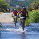 Riders Nicola Biani and Marco Abrahams cross the Berg River  and during stage 5 of the 2022 Absa Cape Epic Mountain Bike stage race from Elandskloof in Greyton to Stellenbosch, South Africa on the 25th March 2022 © Dom Barnardt / Cape Epic